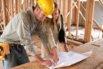 architect and construction worker looking at blueprint