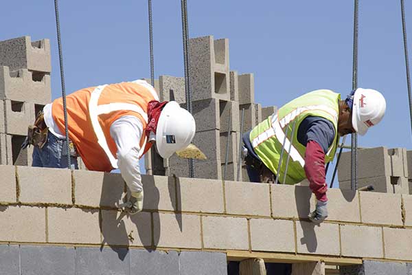 construction workers building wall